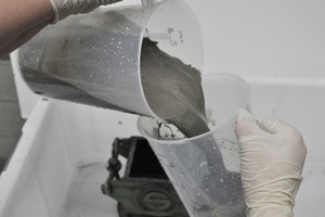  3	 Sample manufacturing of two-component mortar in laboratory: a) Mixing the components;  