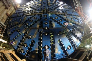  The 13.7 m diameter Slurry machine was designed to bore in abrasive granitic rock up to 130 MPa UCS at high water pressures. Robbins crews assisted the JV Obayashi-Taisei-Kosei contractor during Onsite First Time Assembly of the massive TBM in a jobsite just 30 m wide and 60 m long 