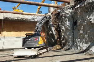  After cutting a segment free it is pulled down to the floor using the excavator bucket 