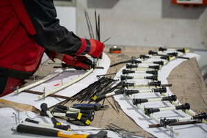  Straight glass fiber rods and shaping brackets made from Schöck Combar are tied together by hand 