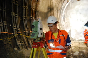  Surveying activities: surveyor measuring the traverse with total station and measuring crew during levelling 