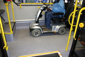  	Attempting to manoeuvre an E-scooter aboard a bus 