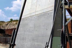  A completed section of the wing wall which tapers at the side facing the water. The upper lighter concrete part is the exposed concrete section.  