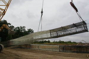  In July 2015, Combar was used for the construction of the launching shaft at the Rastatt Tunnel. The middle part of the reinforcement cage consists of glass fibre reinforcement, which can be simply bored through by the tunnel boring machine. The picture shows the erection of a reinforcement cage before it is lowered into the panel 